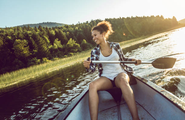 istock Young Woman Canoeing on the Lake 981587544