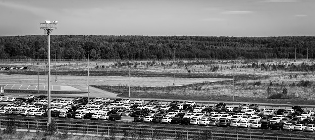 Volkswagen, Russia, Kaluga  - MAY 17, 2018: New cars parked at distribution center, automobile factory. Monochrome.