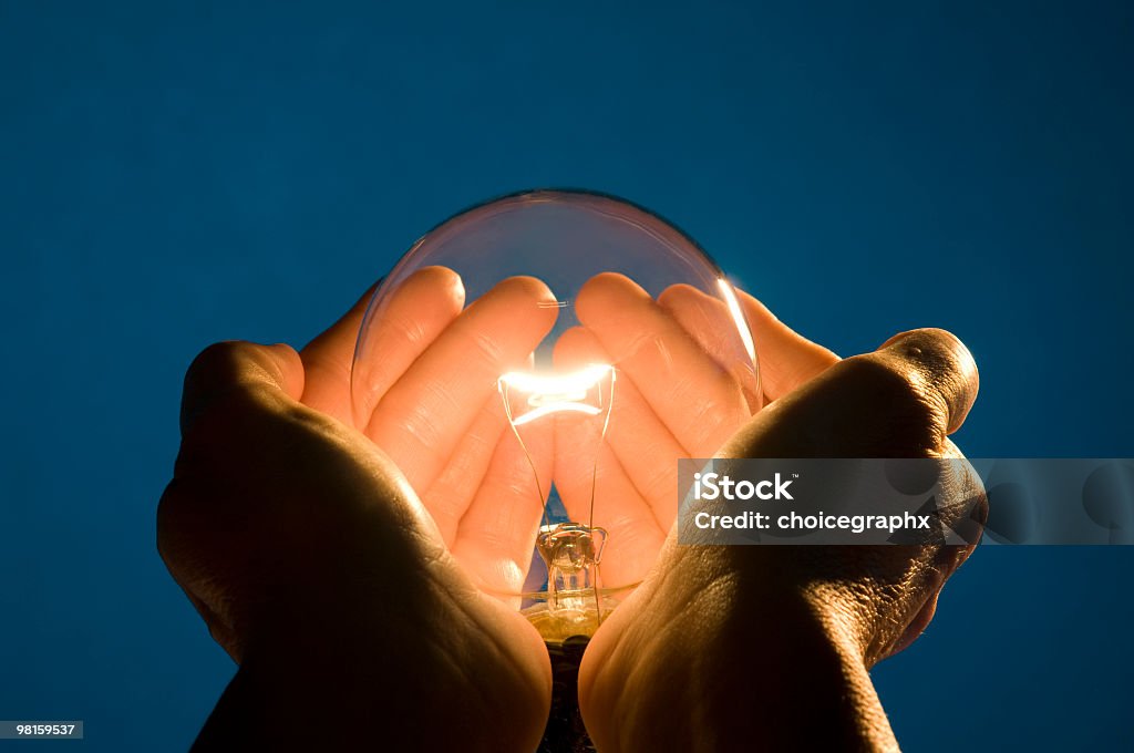 Holding Energy in the Palms of my Hands Holding Energy in the Palms of my Hands, displays a clear incandescent light bulb position in the open hands of a woman   Palm of Hand Stock Photo