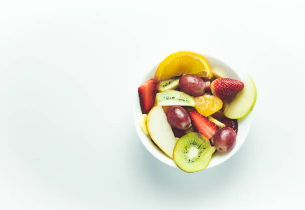 istock tropical fruit salad on wooden background 981599312