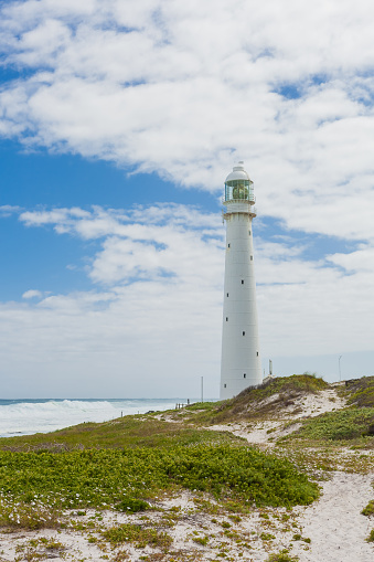 Large White Lighthouse on the rugged Atlantic Coast of Cape Town South Africa