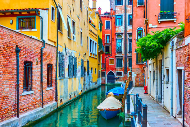istock Side canal with moored motorboats in Venice 981605036