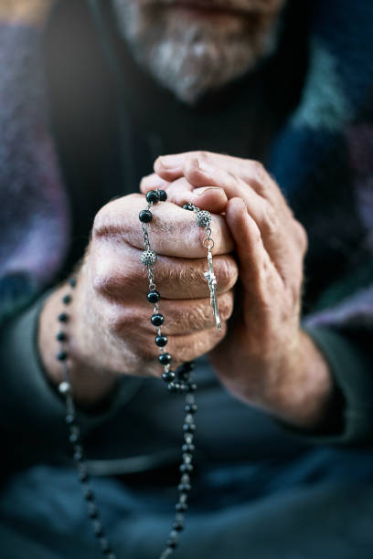 istock Hands of a man holding a rosary 981605346