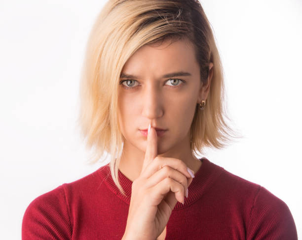 istock Fingers on lips- girl making silence gesture shh sign Isolated on white 981607106