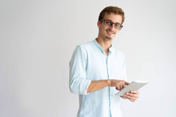 istock Cheerful excited young businessman touching tablet screen 981613020