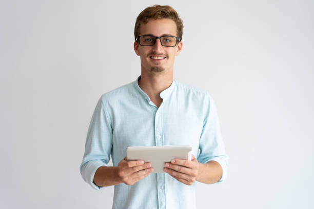 istock Jolly excited handsome male specialist working with tablet 981613080