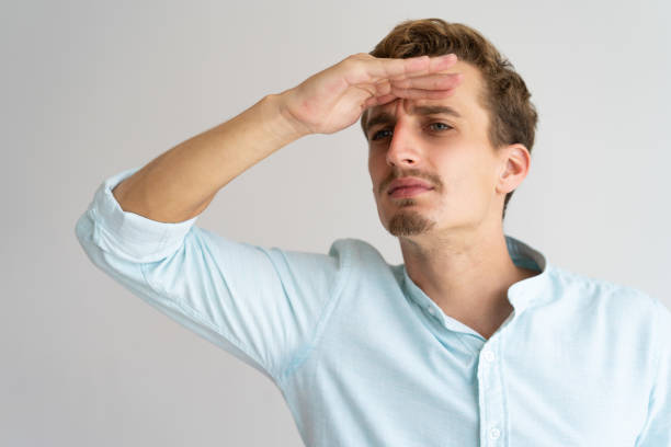 istock Focused frowning handsome guy looking far away 981613436