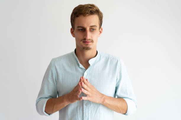 istock Concerned serious guy in white casual shirt thinking 981614478