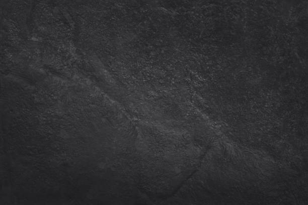 istock Dark grey black slate texture in natural pattern with high resolution for background and design art work. Black stone wall. 981616012