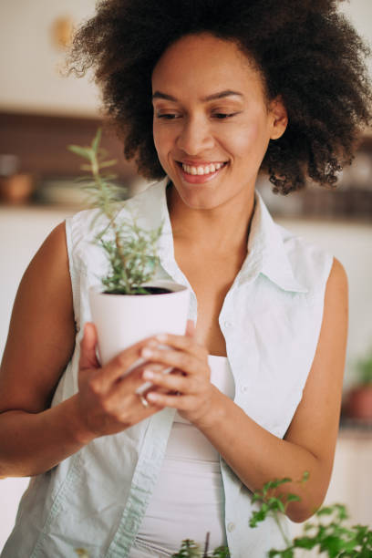istock Woman holding flower pot. 981616908