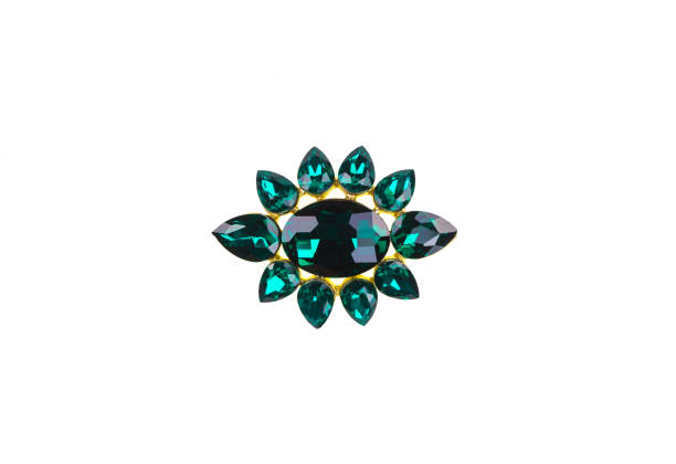 istock brooch with emeralds on a white background 981623332