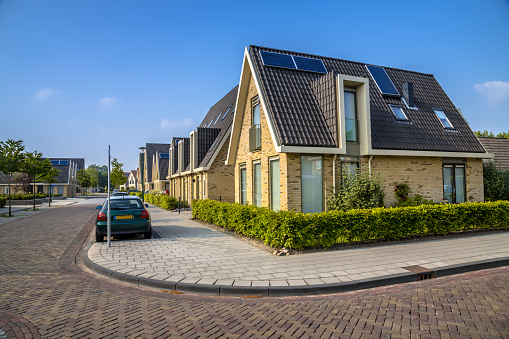 Modern family houses in residentieal street of middle sized city in Friesland