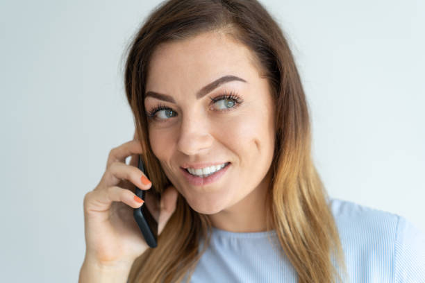 istock Smiling pretty woman talking on smartphone 981626994