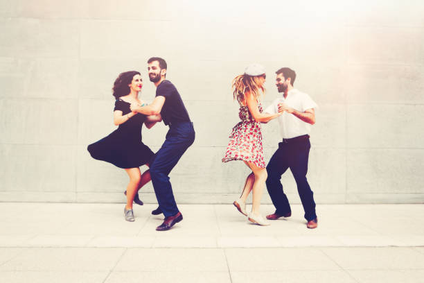 Two beautiful couples dancing in the city dancing an jumping lindy hop stock pictures, royalty-free photos & images