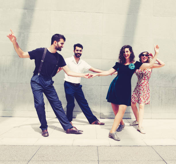 istock Two beautiful couples dancing in the city 981632608