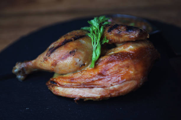istock Grilled chicken on black dish wood background 981633886