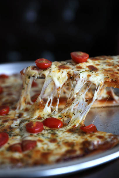 istock Pizza cherry tomato on wood background 981633916