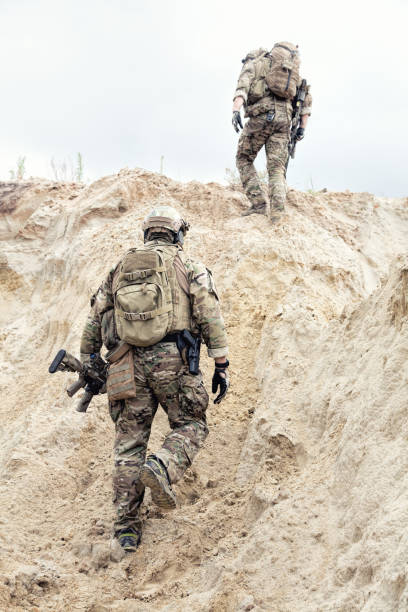 istock Military scouts walking through sands in desert 981638712
