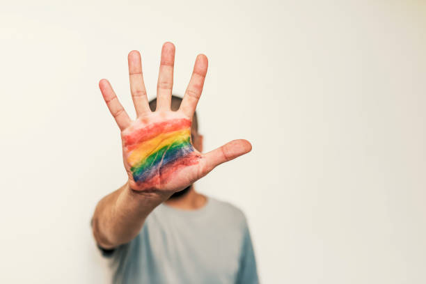 lgbt symbol in the palm of the hand - flag rainbow gay pride flag gay man imagens e fotografias de stock