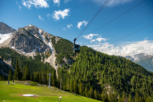 View of the cable car arriving at the mid station on Rosshütte in the Austrian Alps.