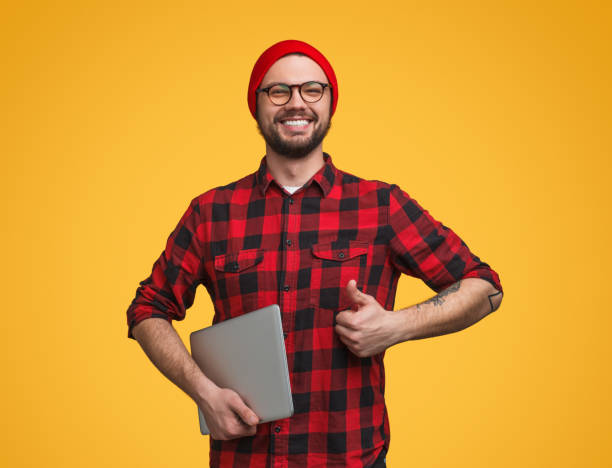 istock Youngster with laptop with thumb 981643228