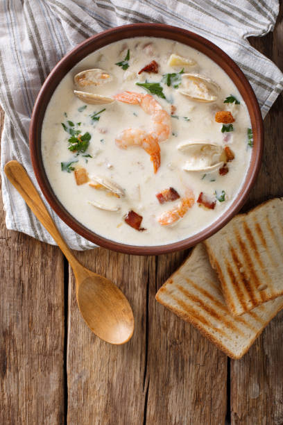 istock American cuisine: New England clam chowder soup closeup. Vertical top view 981661218