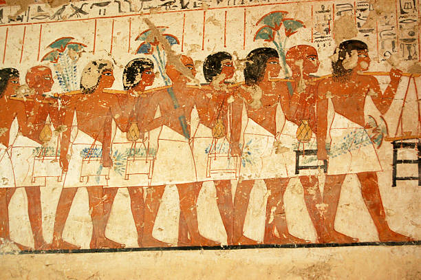 Ancient Egyptian tomb painting of people serving the pharaoh stock photo