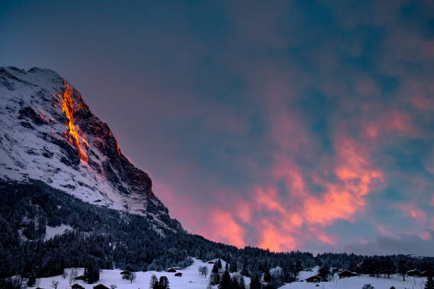 Fiescherwand Faulhorn in the Grindelwald Switzerland with Eiger in the Bernese Alps. Sunset with red sky and clouds in the sunset.