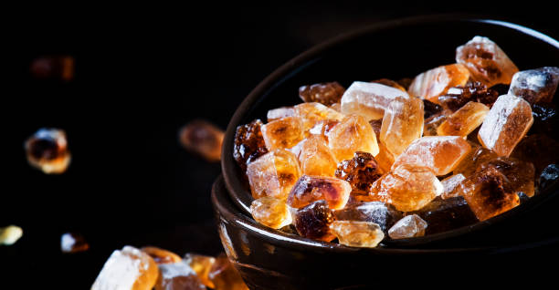 istock Brown candy cane sugar in clay bowl 981708524