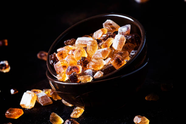 istock Brown candy cane sugar in clay bowl 981709930