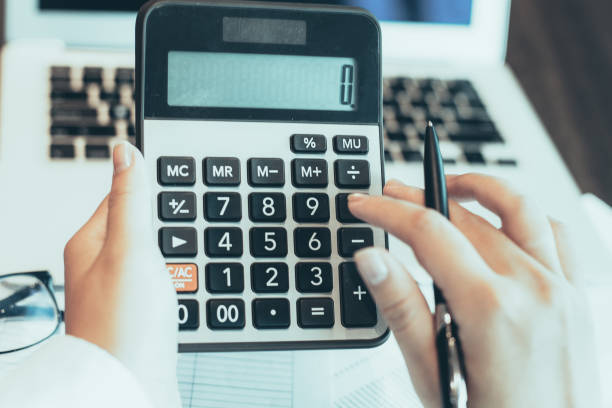 istock Female hands counting with calculator in office 981710616
