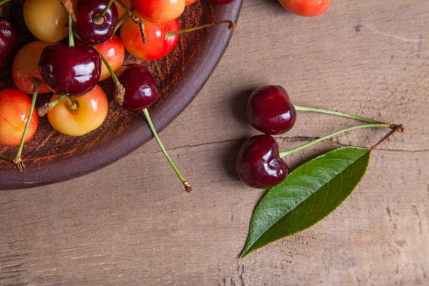 istock Clay plate with yellow and red sweet cherry 981727760