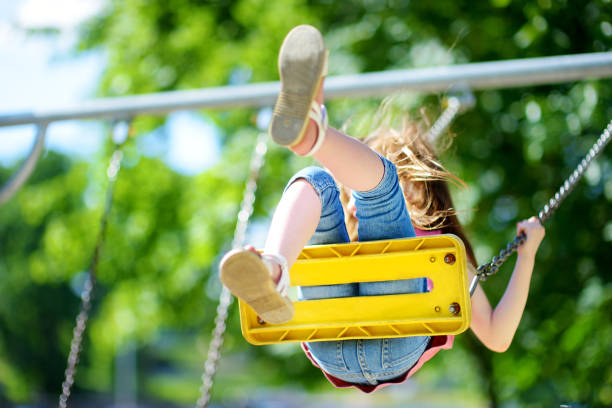 istock Cute little girl having fun on a playground 981728120