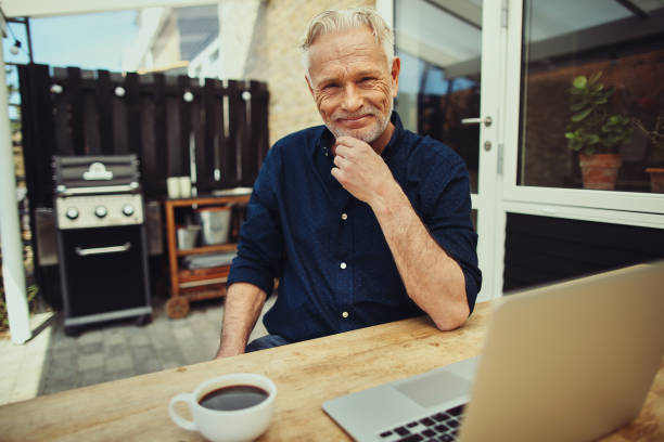 istock Content senior man using a laptop on his patio 981732726
