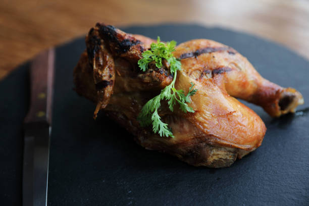 istock Grilled chicken on black dish wood background 981739680