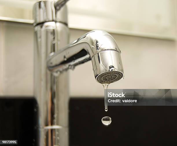 A Silver Tap With A Droplet Of Water Falling Out Stock Photo - Download Image Now - Cold Temperature, Drop, Faucet