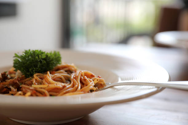 istock spaghetti Bolognese with minced beef and tomato sauce garnished with parmesan cheese and basil , Italian food 981740014