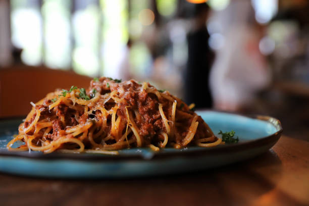 istock spaghetti Bolognese with minced beef and tomato sauce garnished with parmesan cheese and basil , Italian food 981740512