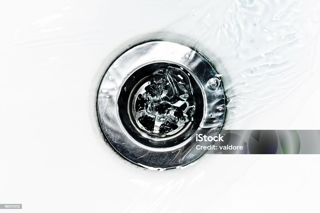 Closeup of Water flowing down a drain Down the drain. Drain Stock Photo