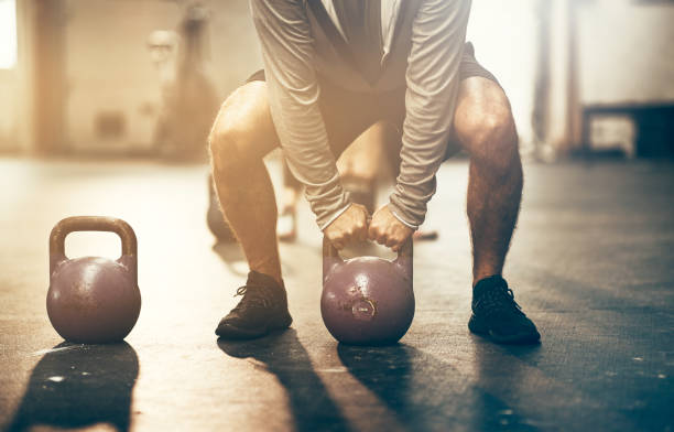 istock Man lifting dumbbells during an exercise session at the gym 981741366