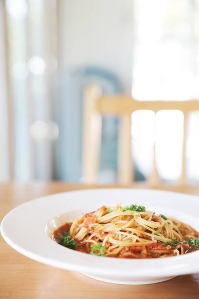 istock spaghetti Bolognese with minced beef and tomato sauce garnished with parmesan cheese and basil , Italian food 981741436