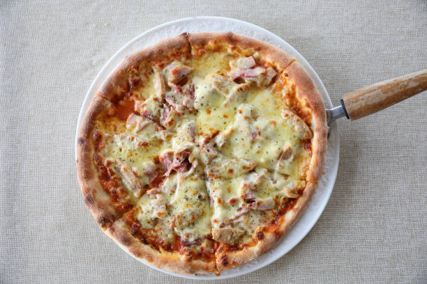 istock Pizza ham bacon with cheese and tomato sauce 981741550