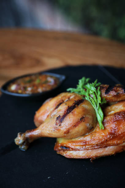 istock Grilled chicken on black dish wood background 981742474