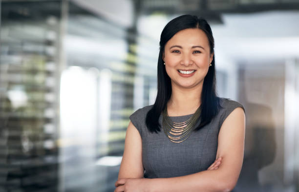 Nothing says success like self confidence Portrait of a confident young businesswoman working in a modern office chinese woman stock pictures, royalty-free photos & images