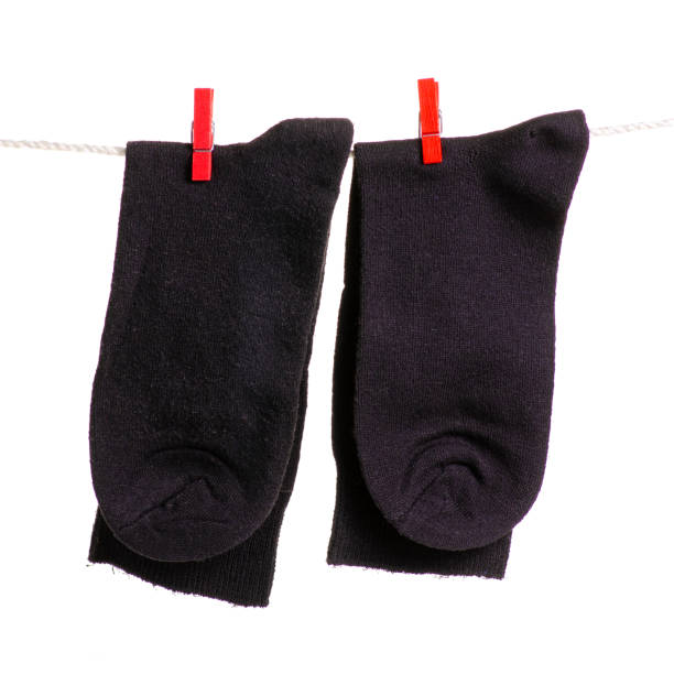 istock Black socks on a rope clothespins 981749640