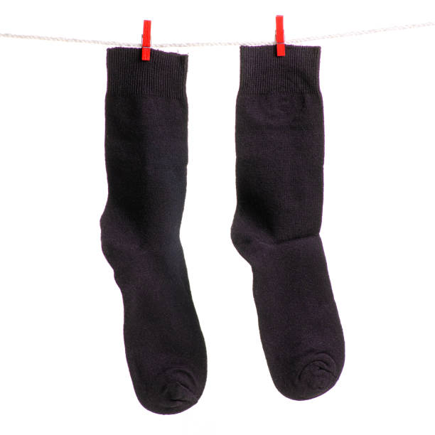 istock Black socks on a rope clothespins 981749648