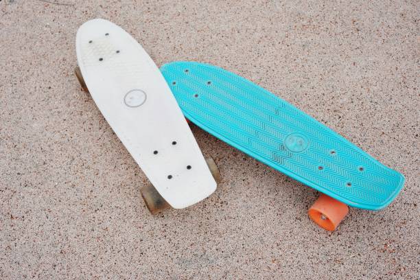 istock High Angle View Of Skateboard On Sand At Beach 981750330