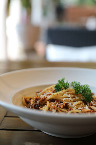 istock spaghetti Bolognese with minced beef and tomato sauce garnished with parmesan cheese and basil , Italian food 981752902