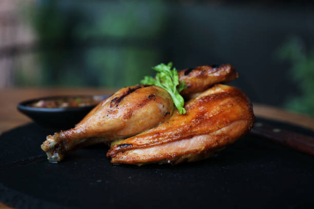 istock Grilled chicken on black dish wood background 981753050