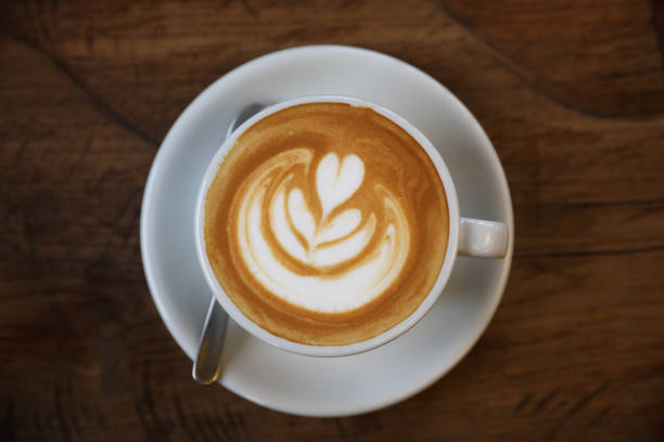 istock Cappuccino coffee cup on wood background 981753396